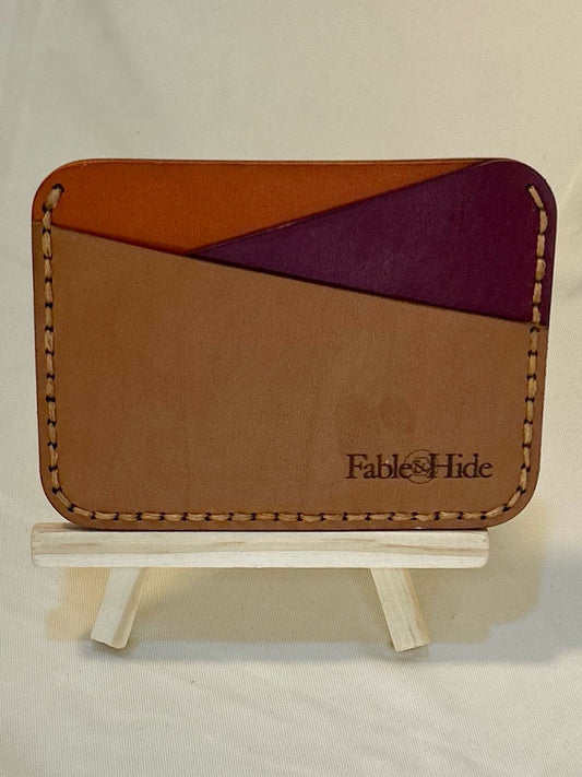 Tan, maroon, and orange card holder with tan stitching 